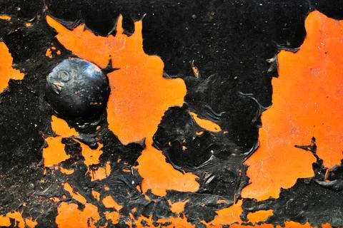 A black and orange surface with a black object in the center Stock Photos