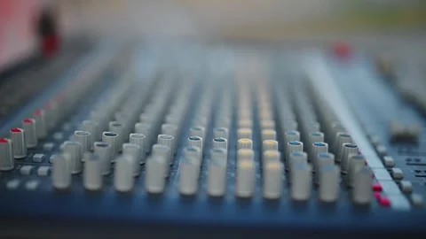A black and silver audio mixing board with a red button in the middle Stock Footage 344915075