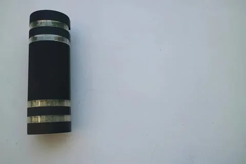 Black and silver modern flashlight on white surface Stock Photos