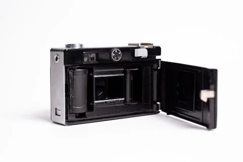 Black and silver retro camera with the back open isolated on a white backgrou Stock Photos