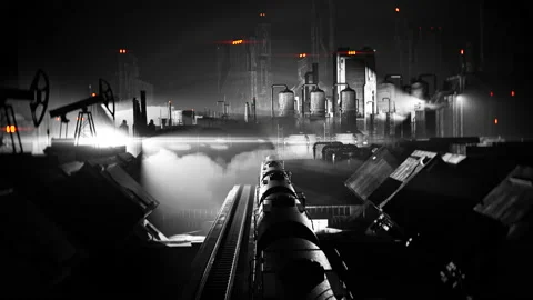 Black and white cargo train moving through industrial district, film noir Stock Footage 130635426