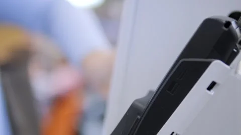 Black and white cell phone is sitting on a white surface Stock Footage 297492132