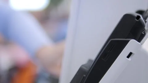 A black and white cell phone is sitting on a white counter Stock Footage 297846953