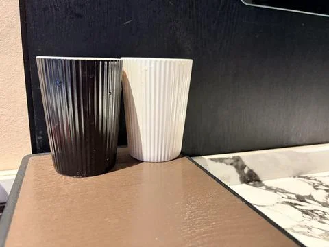 Black and White Ceramic Cups on Modern Kitchen Countertop Stock Photos