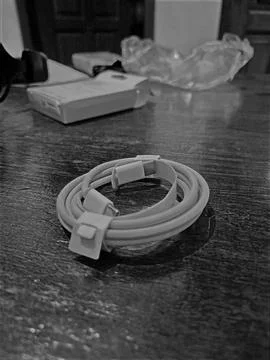 A black and white charging cable is displayed Foto stock