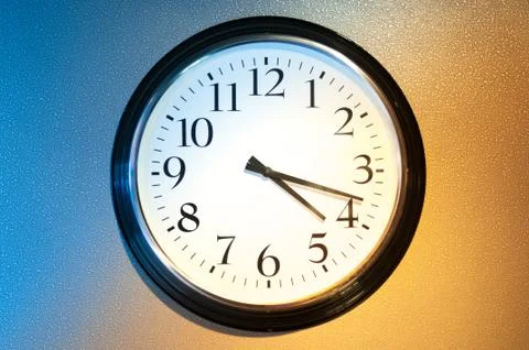 Black-and-white clock with light and shade. Stock Photos