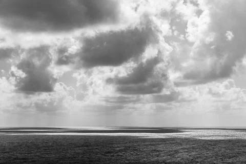 Black and white of clouds casting their shadows on the sea surface Foto stock
