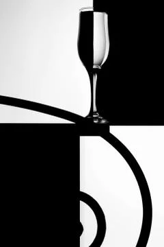 Black and white composition with empty wineglass on a table. Foto stock