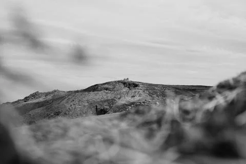 Black and white distant chapel ruin on rugged headland, Saint Ives, Cornwall Stock Photos