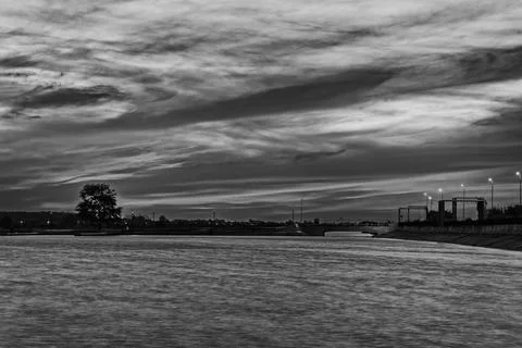 Black and White Dramatic Cloudy Sky over Calm Morii Lake at Dusk, Bucharest Fotos de archivo