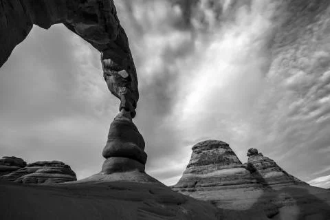 Black and white dramatic sky over delicate arch Stock Photos