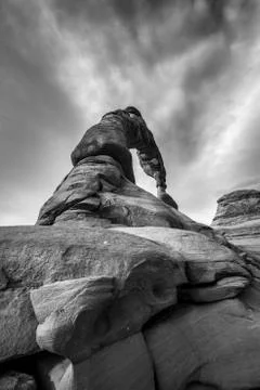 Black and white dramatic sky over delicate arch Stock Photos