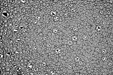 Black and white drops of oil on the water. Circles and ovals. Abstract back.. 스톡 사진