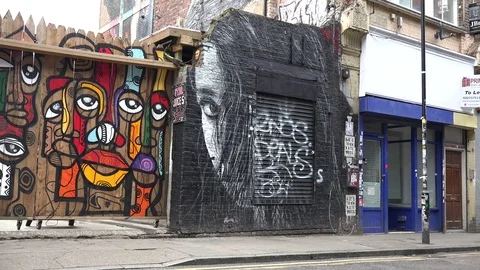 Black and white face graffiti brick lane Stock Footage 73638558