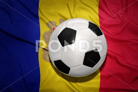Black and white football ball on the national flag of andorra Stock Photos