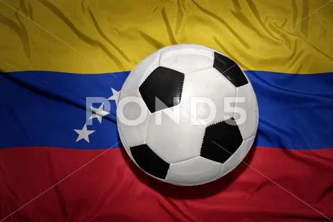 Black and white football ball on the national flag of venezuela Stock Photos