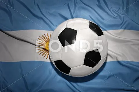 Black and white football ball on the national flag of argentina Stock Photos