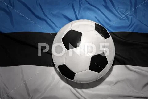 Black and white football ball on the national flag of estonia Stock Photos