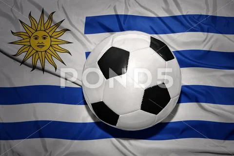 Black and white football ball on the national flag of uruguay Stock Photos