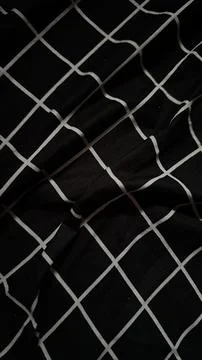 Black and white grid pattern fabric texture draped dark geometric line text.. Stock Photos