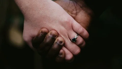 Black and white hands hold ich other Stock Footage 100986302