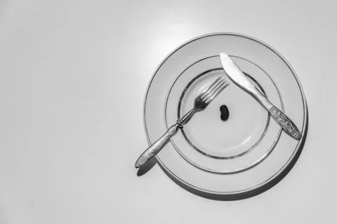 Black and white image of beans on a plate. Stock Photos