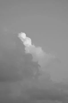A black and white image of clouds at dawn. Stock Photos