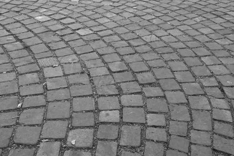 Black and white image of interlocking cobblestone pavement showcasing a detai Stock Photos