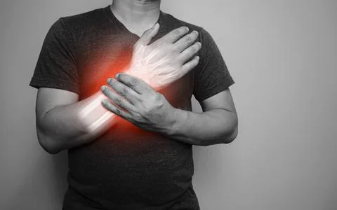 A black and white image of a man with a pain in his right wrist From arthriti Stock Photos
