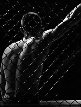 Black and white image of a man in a boxing cage. The concept of sports, MMA Stock Photos