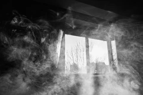 Black and white image of thick mysterious smoke filling a room interior wit.. Stock Photos