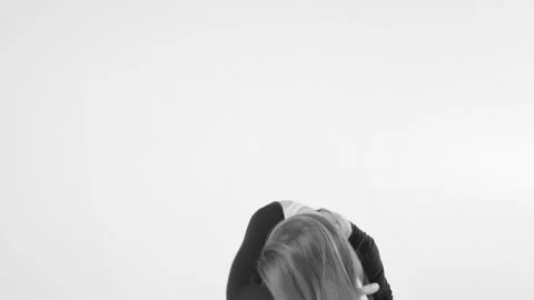 Black and white image. Young woman choreographer dancing in a black suit against Video stock 87263392