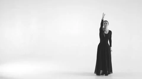 Black and white image. Young woman choreographer dancing in a black suit against Stock Footage 87265563