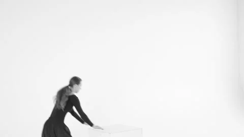 Black and white image. Young woman choreographer dancing in a black suit against Stock Footage 87267739