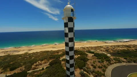 Black and white lighthouse on the beach in Australia Stock Footage 243295636