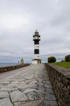 Black and white lighthouse of Ortiguera Asturias on the Atlantic coast of Spa Stock Photos