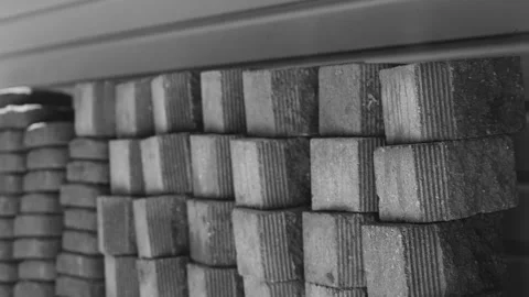 Black and white look at bricks stacked against a wall in the shade. Stock Footage 340923590