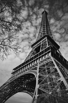 Black and White Low Angle View of the Eiffel Tower Against a Dramatic Sky Stock Photos
