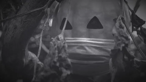 Black and white old style video 4k of halloween 2020 pumpkin with a face mask Stock Footage 140846832