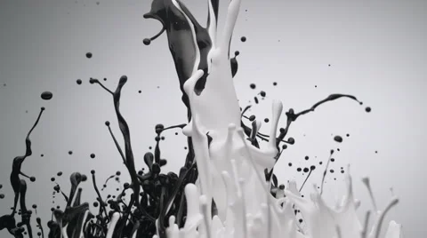 Black and white paint bouncing and making splash. Slow Motion. Stock Footage