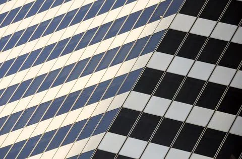 Black and white pattern made by the lines and windows from the facade of a bu Stock Photos