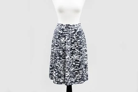 Black and white patterned long skirt hangs on a legless mannequin. Stock Photos