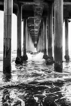 Black and white perspective under the Huntington Beach Pier in Huntington B.. Stock Photos