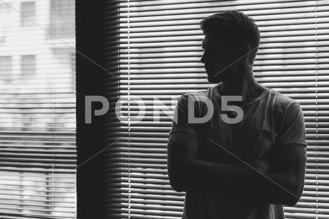 Black And White Photo Of A Muscular Guy Looking At Nine O'clock