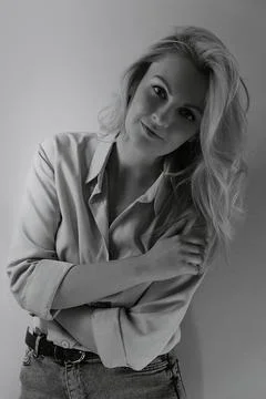 Black and white photograph of a girl in a shirt and jeans. Stock Photos