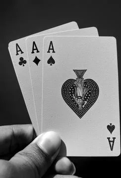 Black and White Playing Cards all aces aligned in the corner, holding fingers Stock Photos