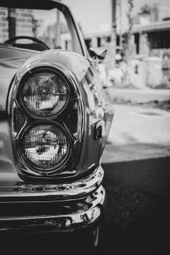 A black and white portrait of the front right headlights of an old timer car  Stock Photos
