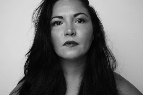 Black and white portrait of pretty thoughtful woman with serious expression. Stock Photos