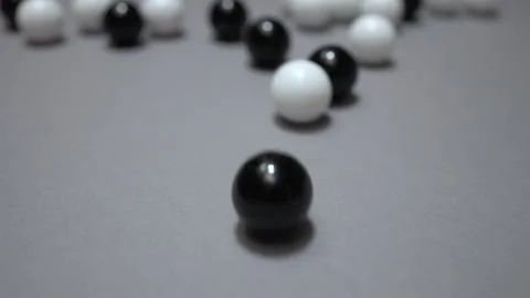 Black and white rolling toward camera on gray surface Stock Footage 147462202