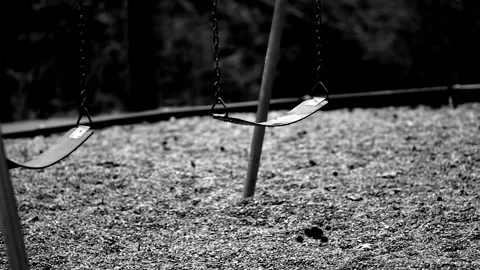 Black and white scene of Empty swings in a park  Stock Footage 133658370
